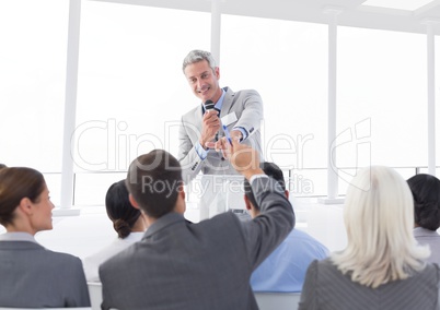 Businessman interacting with colleagues in conference hall