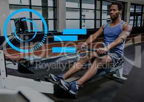 Fit man performing seated row exercise in gym with fitness interface