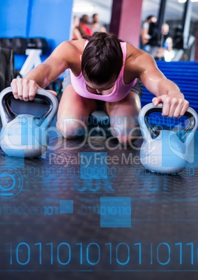 Fit woman performing fitness exercise using kettlebell in gym with fitness interface
