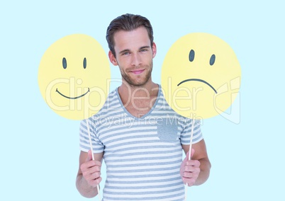 Man holding a smiley face and sad face
