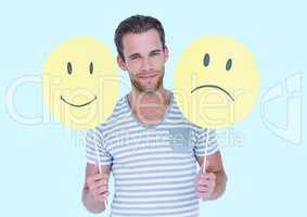 Man holding a smiley face and sad face