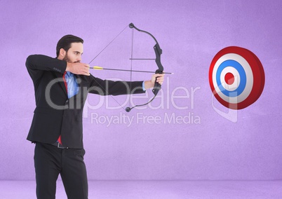 Successful businessman aiming target with bow and arrow against purple background
