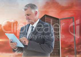 Digital composite image of businessman using digital tablet against server tower