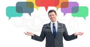 Businessman making hand gestures against chat bubbles in background