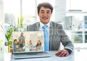 Portrait of businessman having video call on laptop in office