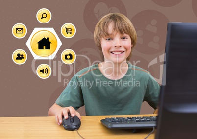 Smiling boy using desktop pc with various application icons in background