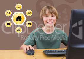 Smiling boy using desktop pc with various application icons in background
