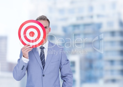 Businessman holding target in front of face