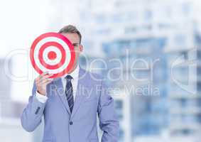 Businessman holding target in front of face