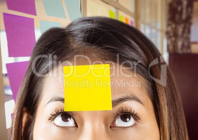 Close-up of woman with sticky note on her forehead