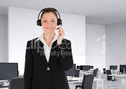 Portrait of customer service woman in headset standing in office