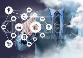 Businessman touching applications interface against clouds