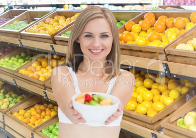 Woman with fruit bowl in supermarket