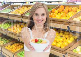 Woman with fruit bowl in supermarket