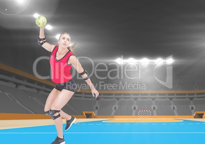 Athlete playing handball against stadium in background
