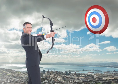 Portrait of businessman aiming with bow and arrow at target over cityscape