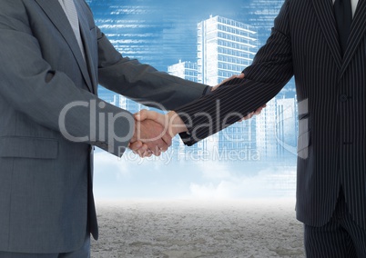 Business professionals shaking hands against cityscape in background