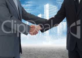 Business professionals shaking hands against cityscape in background