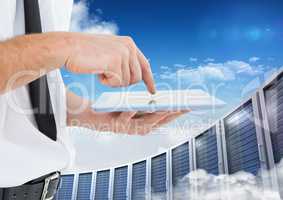 Man using digital tablet against office building in background