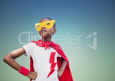 Super kid in red cape and yellow mask standing with hand on hip