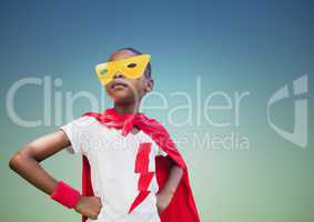 Super kid in red cape and yellow mask standing with hand on hip