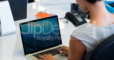 Woman working on laptop at desk