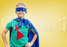 Boy in superhero costume standing with his hands on his waist