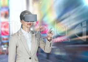 Businesswoman using virtual reality glasses against city in background