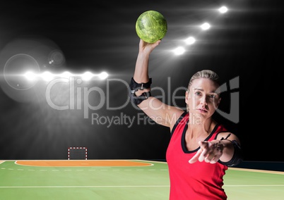 Portrait of a female handball player holding ball at handball court