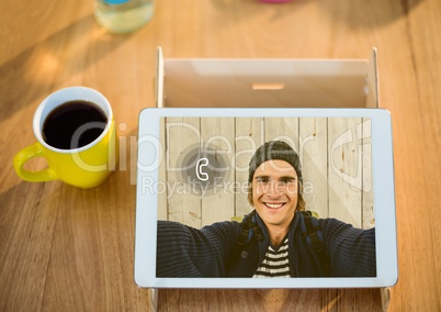 Digital tablet displaying man on video calling screen