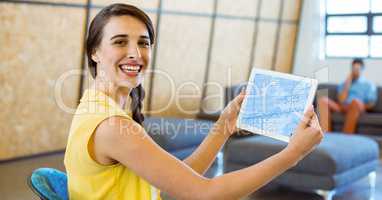 Portrait of smiling woman using digital tablet