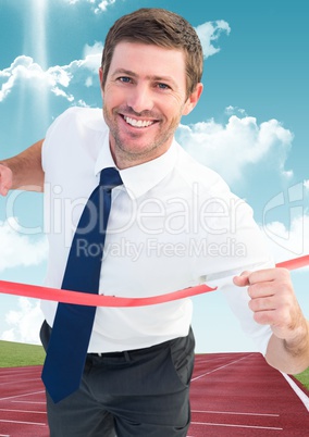 Businessman crossing finish line on a racing track
