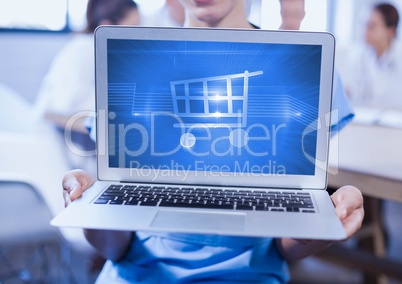 Man holding a laptop showing shopping cart on screen