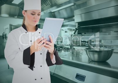 Chef using digital tablet in commercial kitchen