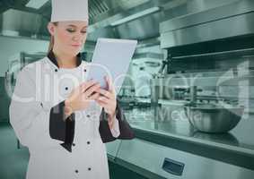 Chef using digital tablet in commercial kitchen