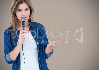 Portrait of beautiful woman singing a song on microphone