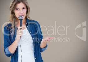 Portrait of beautiful woman singing a song on microphone