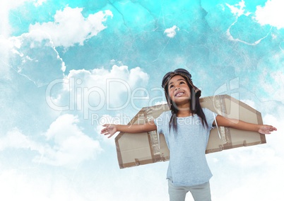 Smiling girl pretending to be a pilot against cloudy sky background