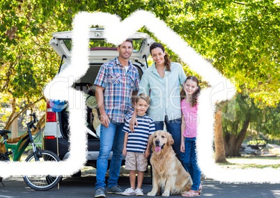 Family and dog standing on the road against house outline in background
