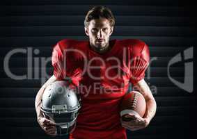 American football player holding rugby ball and helmet against digitally generated background