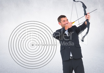 Businessman aiming at the target board against grey background