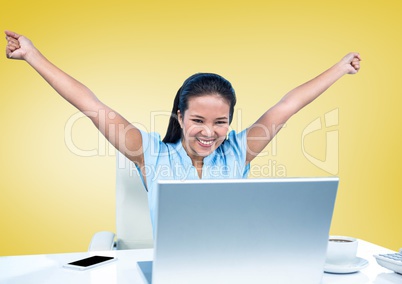 Cheerful businesswoman sitting with her arms raised on office desk