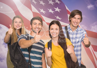 Group of happy teenagers showing thumbs up sign against American flag
