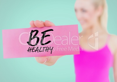 Woman holding placard with text be healthy
