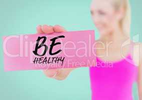 Woman holding placard with text be healthy