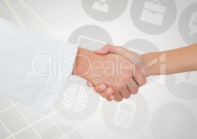 Close-up of businessman and woman shaking hands with various icons in background