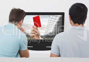 Rear view of men watching television in living room