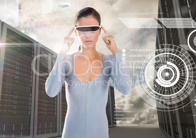 Woman using virtual reality glasses against server rooms