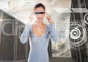 Woman using virtual reality glasses against server rooms