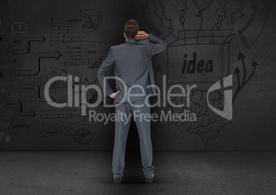 Rear view of confused businessman looking at business concept on grey background